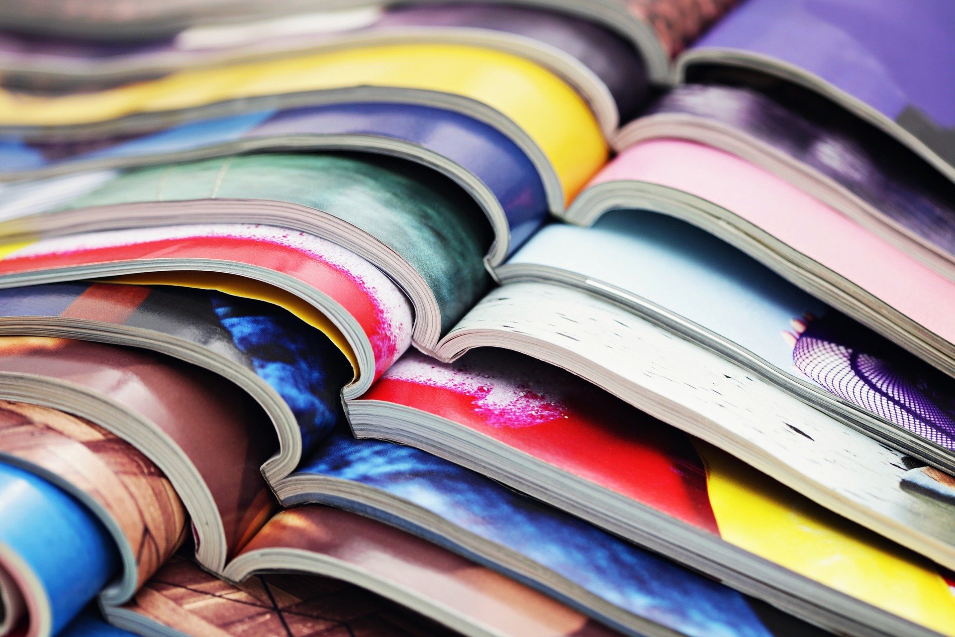 Photo of stacked, opened magazines