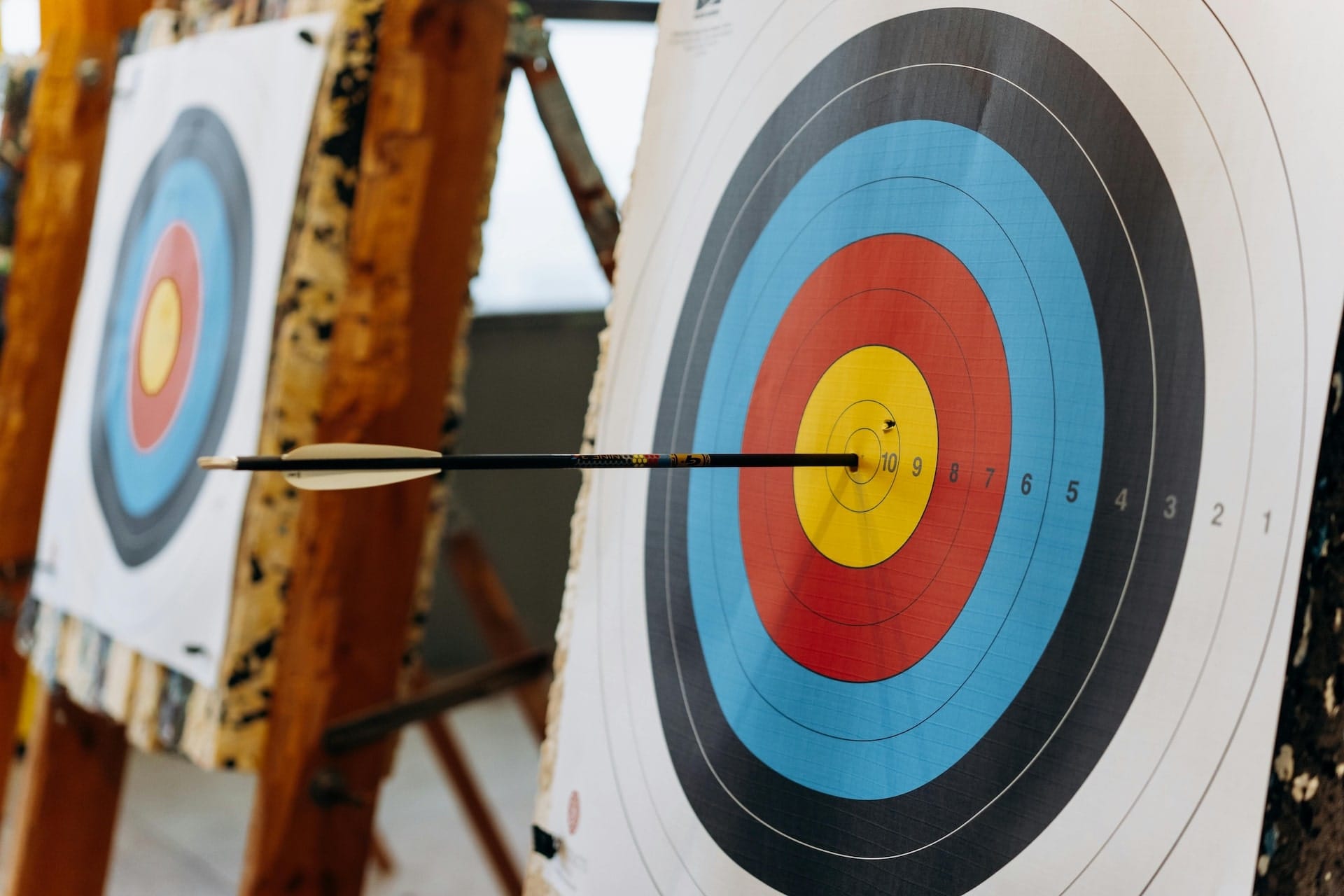 A photo of an arrow impaled in a target